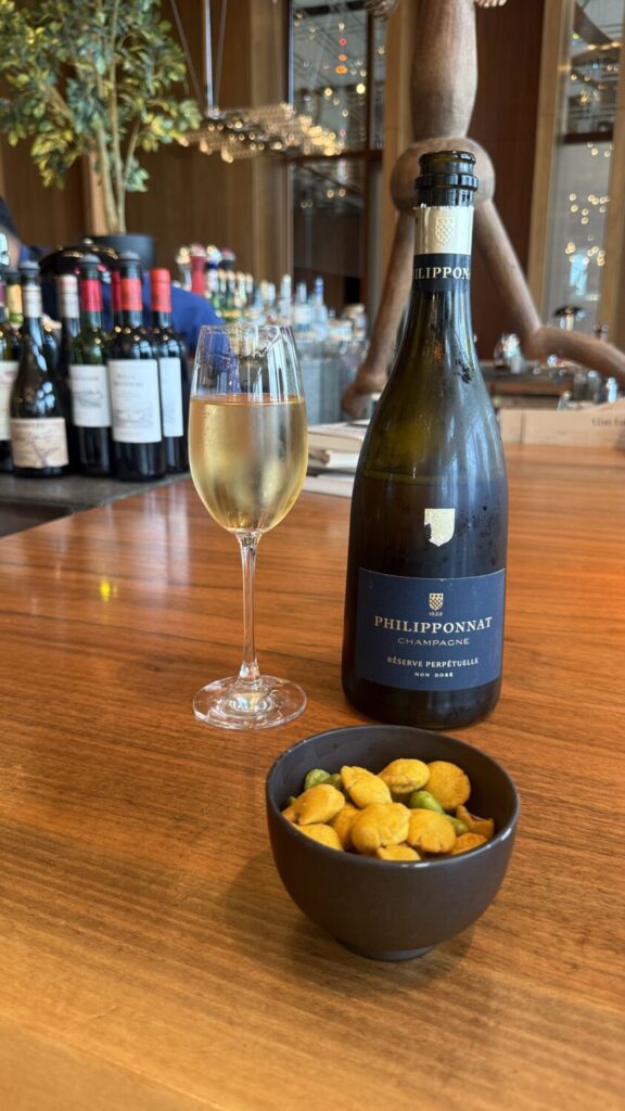 A glass of wine and snacks during happy hour at Andaz Tokyo Toranomon Hills